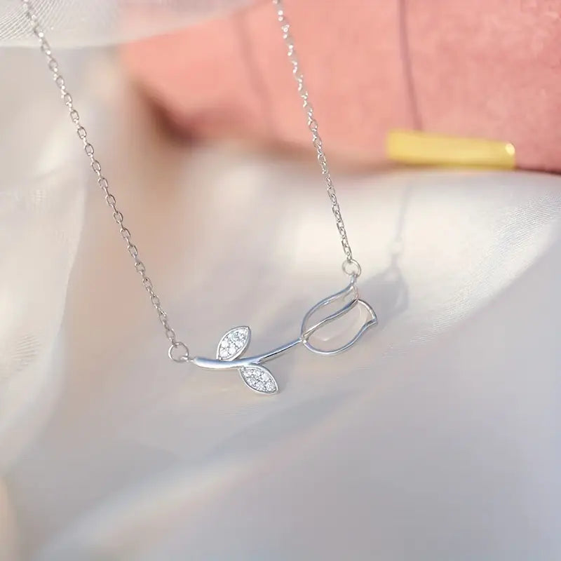 Elegant 925 sterling silver necklace with a delicate botanical pendant featuring a tiny plant motif and zircon accent.