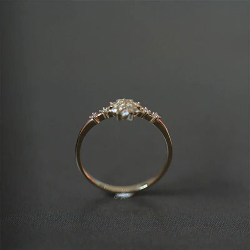 Delicate 925 sterling silver ring with 14k gold plating, featuring a romantic snowflake design and sparkling zircon center.