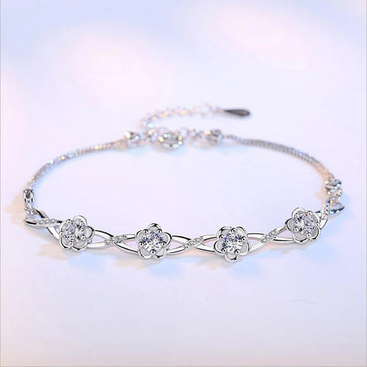 Delicate 925 sterling silver bracelet with a plant motif, sparkling cubic zirconia, and crystal accents for elegant style.