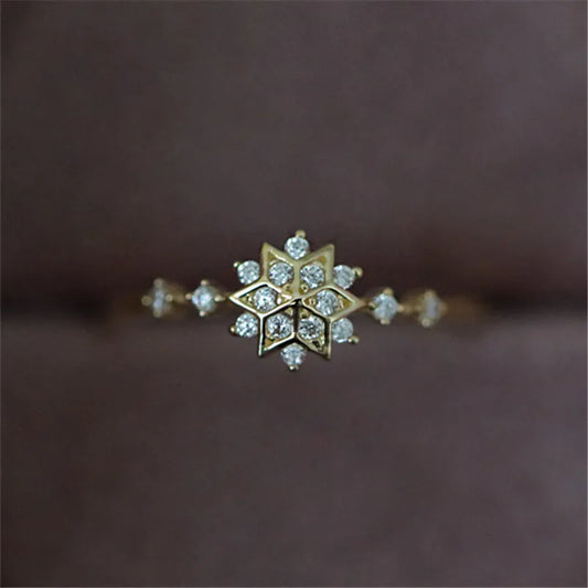 Delicate 925 sterling silver ring with 14k gold plating, featuring a romantic snowflake design and sparkling zircon center.