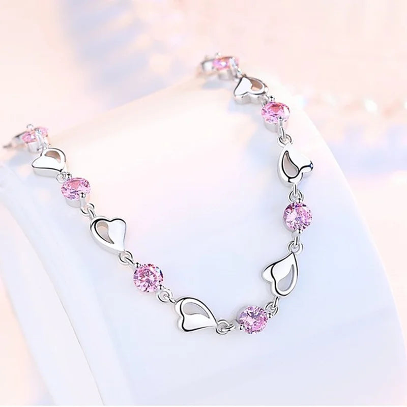 Delicate 925 sterling silver bracelet with sparkling zircon heart-shaped crystals, showcasing a whimsical and trendy design.