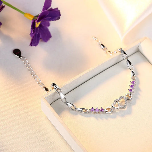 Delicate 925 sterling silver bracelet with shimmering purple crystal zircon hearts, perfect for romantic occasions.