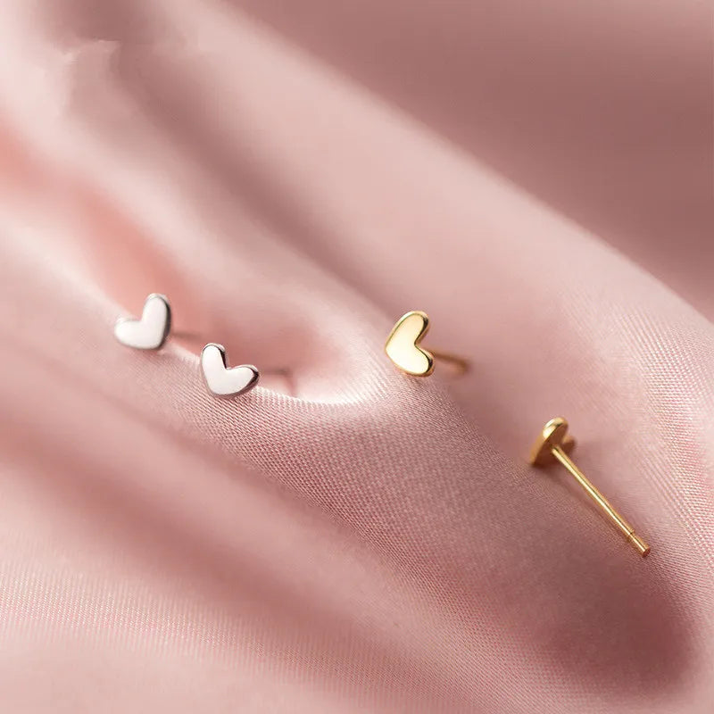 Delicate 925 Sterling Silver Mini Love Heart Stud Earrings with a chic, minimalist geometric design for everyday elegance.