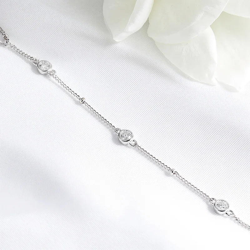 Gleaming 925 sterling silver bracelet with sparkling round-cut Moissanite stones, showcasing a sleek, unisex design.