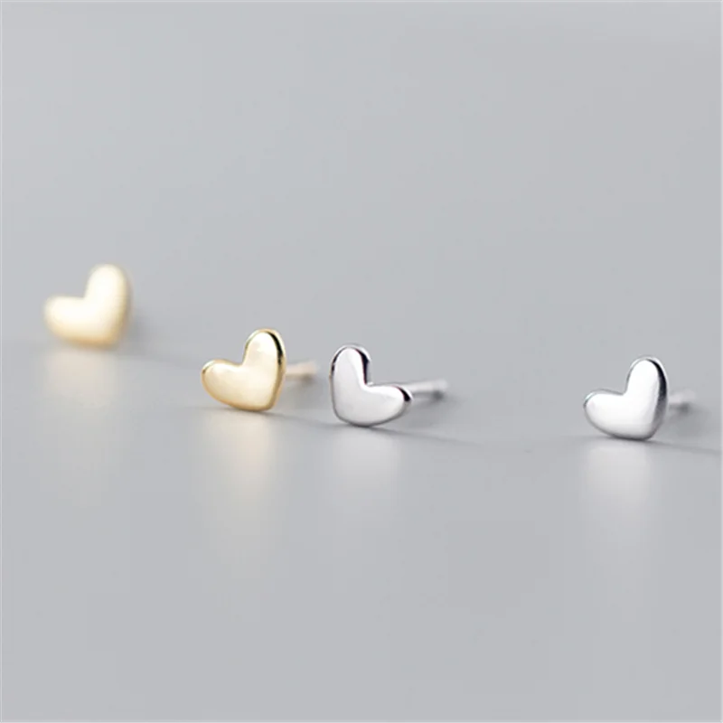 Delicate 925 sterling silver mini heart stud earrings with a chic, geometric design, perfect for everyday elegance.