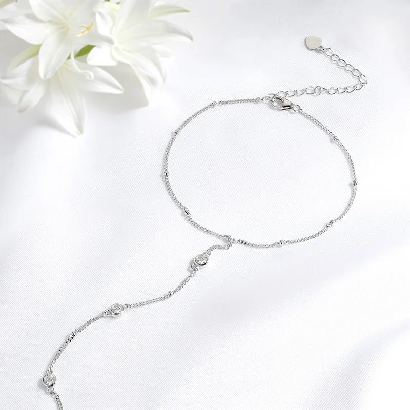 Gleaming 925 sterling silver bracelet with sparkling 18K-plated Moissanite stones in a timeless, unisex charm design.