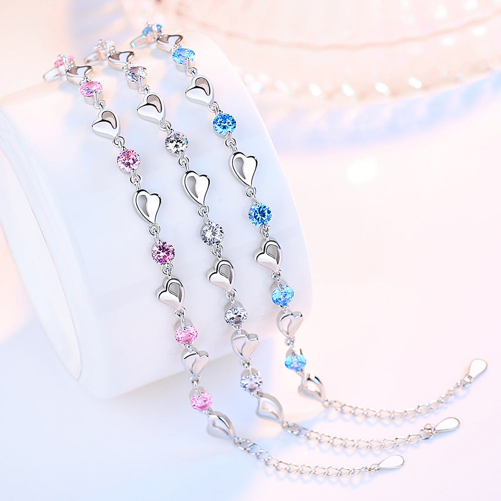 Delicate 925 sterling silver bracelet with sparkling zircon crystals forming a charming heart-shaped design.