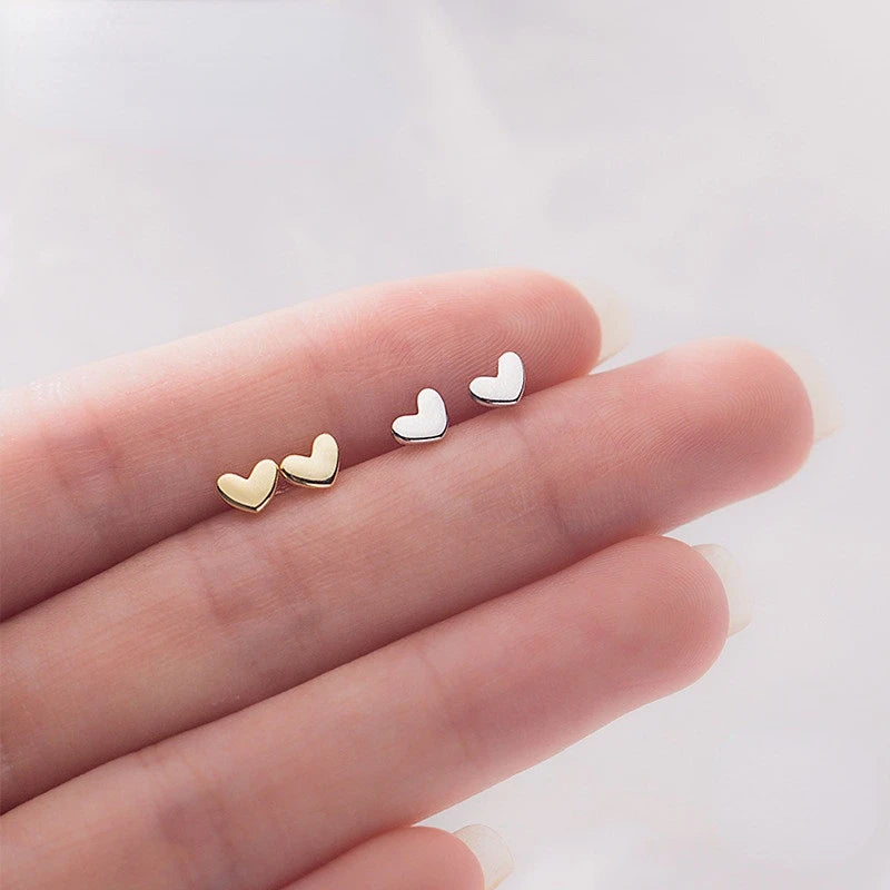 Delicate 925 sterling silver mini heart stud earrings with a chic, minimalist design, perfect for everyday elegance.