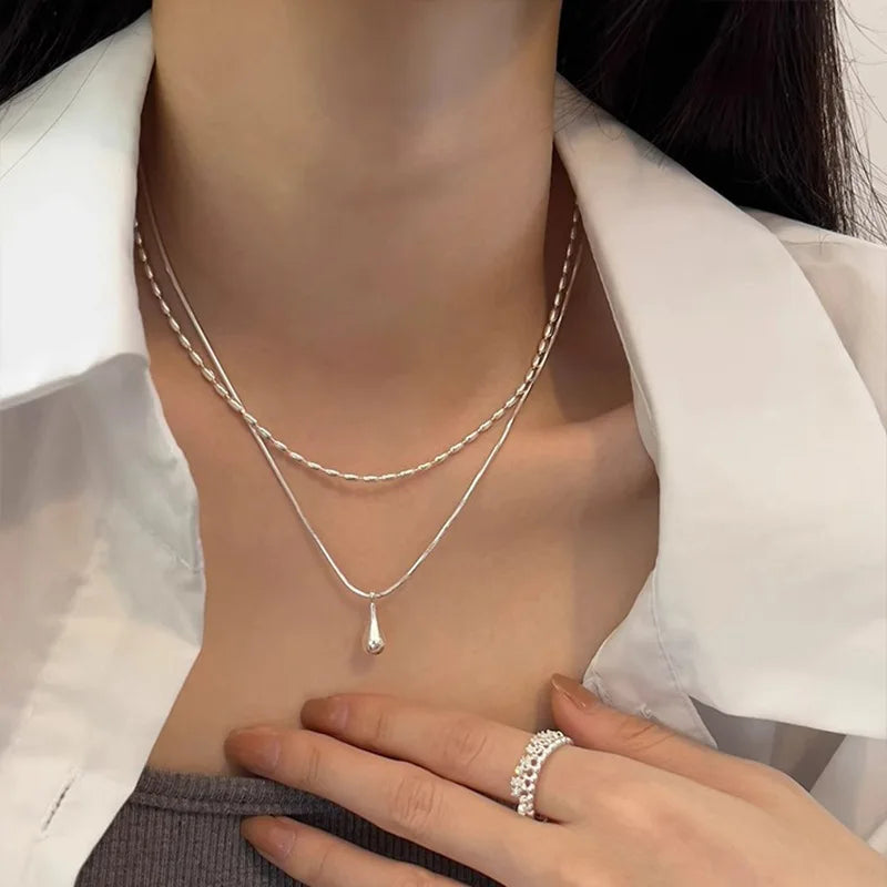 Delicate 925 sterling silver double layer necklace with a handmade pendant, showcasing a timeless and elegant design.