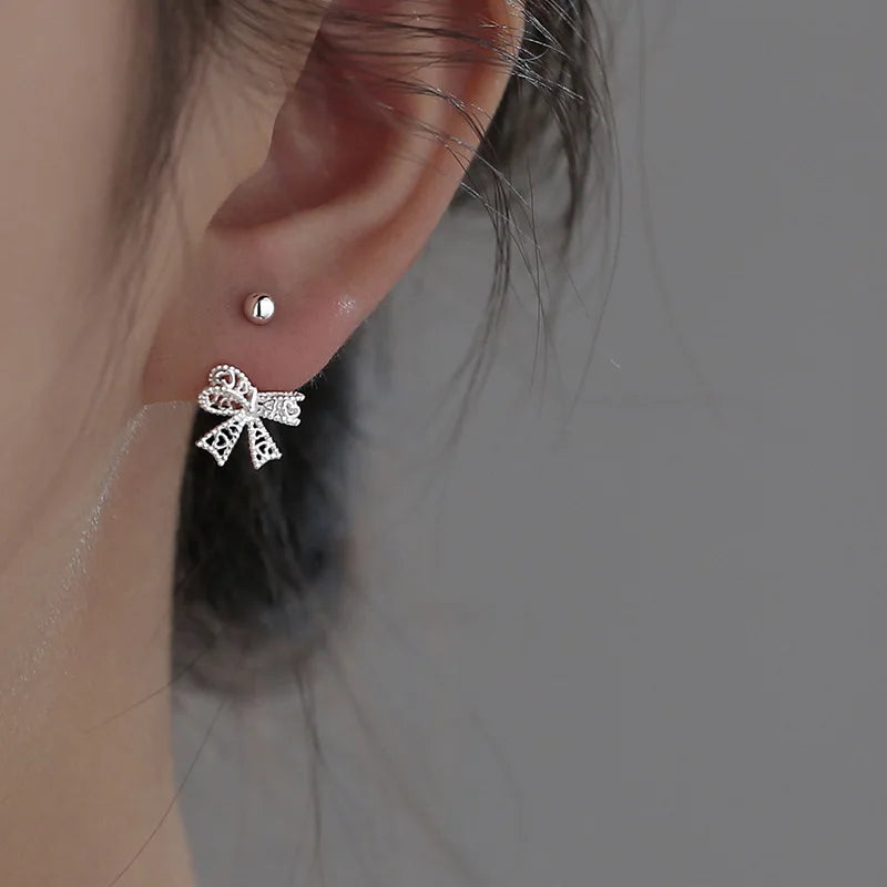 Charming 925 sterling silver bowknot stud earrings with a delicate, romantic design, perfect for any special occasion.
