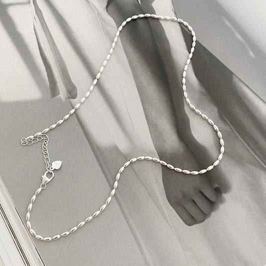 Elegant sterling silver necklace with a geometric zircon pendant sparkling on a delicate 40cm box chain.