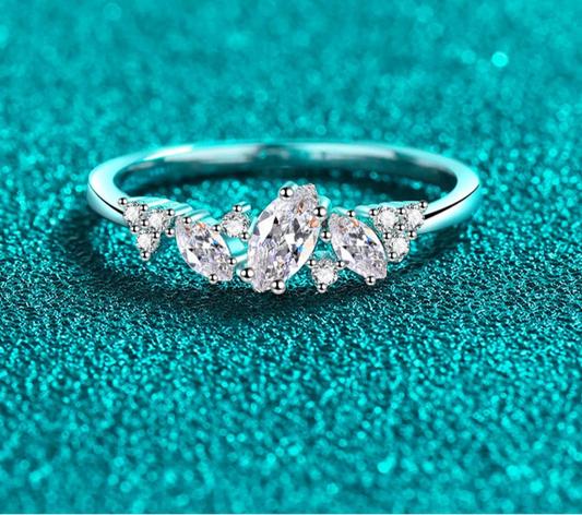 Stunning marquise-cut moissanite solitaire ring in a sleek 4-prong sterling silver setting, perfect for engagements.