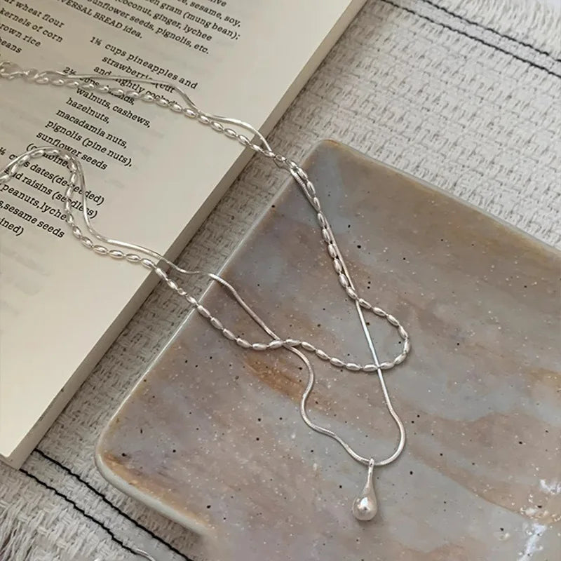 Delicate 925 sterling silver double-layer necklace with a handmade pendant, showcasing a timeless and elegant design.