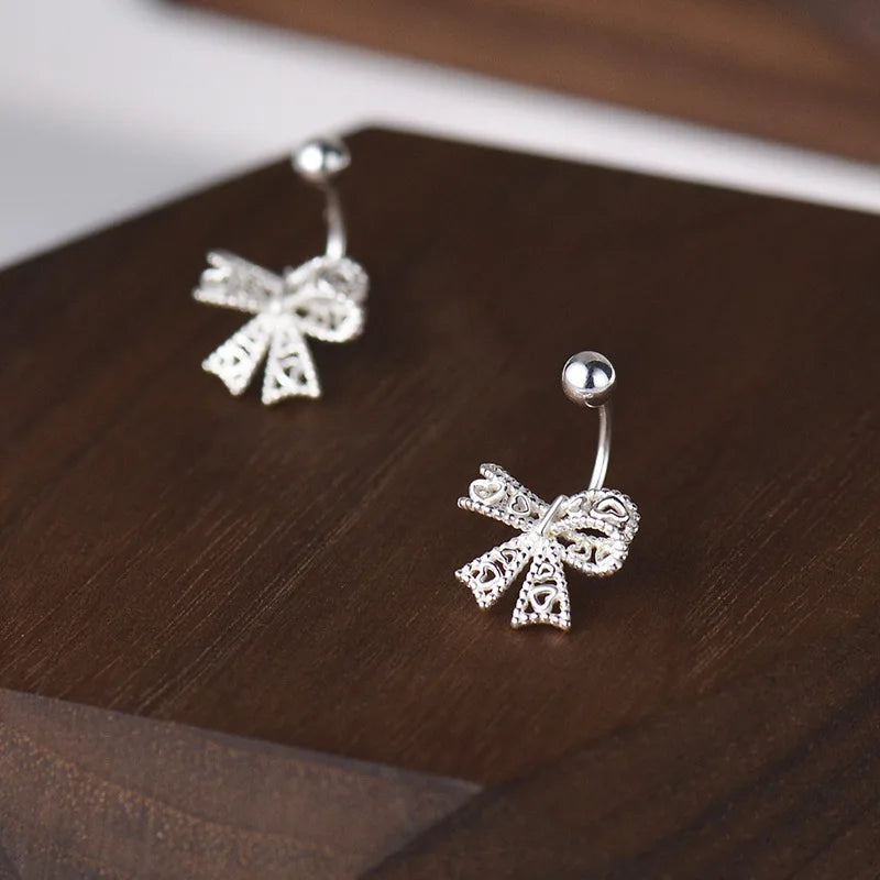 Charming 925 sterling silver bowknot stud earrings with a delicate, romantic design, perfect for any special occasion.