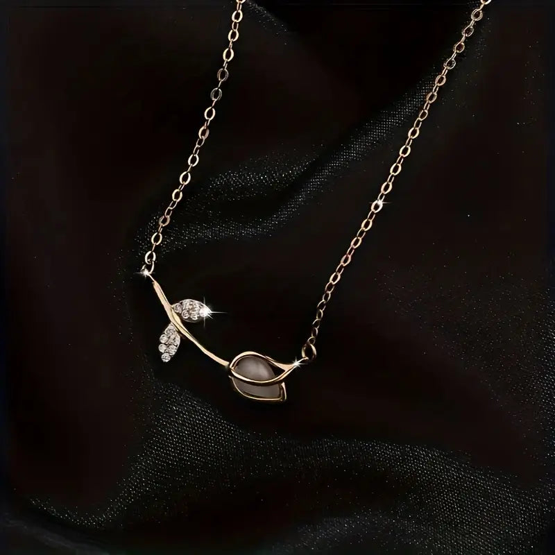 Delicate 925 sterling silver necklace with a tiny botanical pendant featuring a plant motif and sparkling zircon accent.