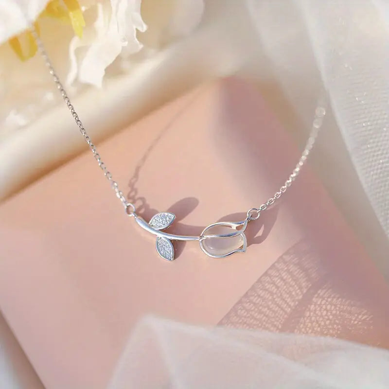 Elegant 925 sterling silver necklace with a tiny botanical pendant featuring a sparkling zircon accent and adjustable chain.