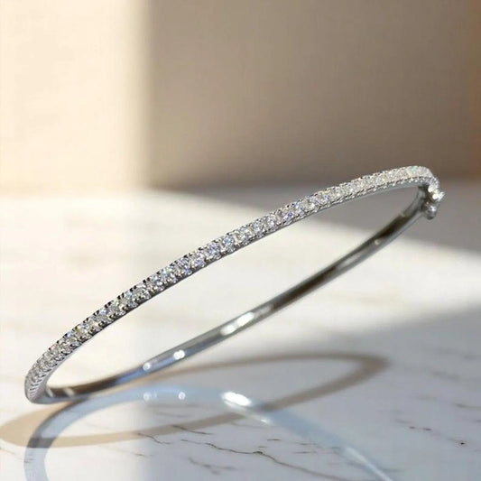 Gleaming gold-filled sterling silver bangle with a sparkling zircon stone centerpiece, showcasing minimalist elegance.