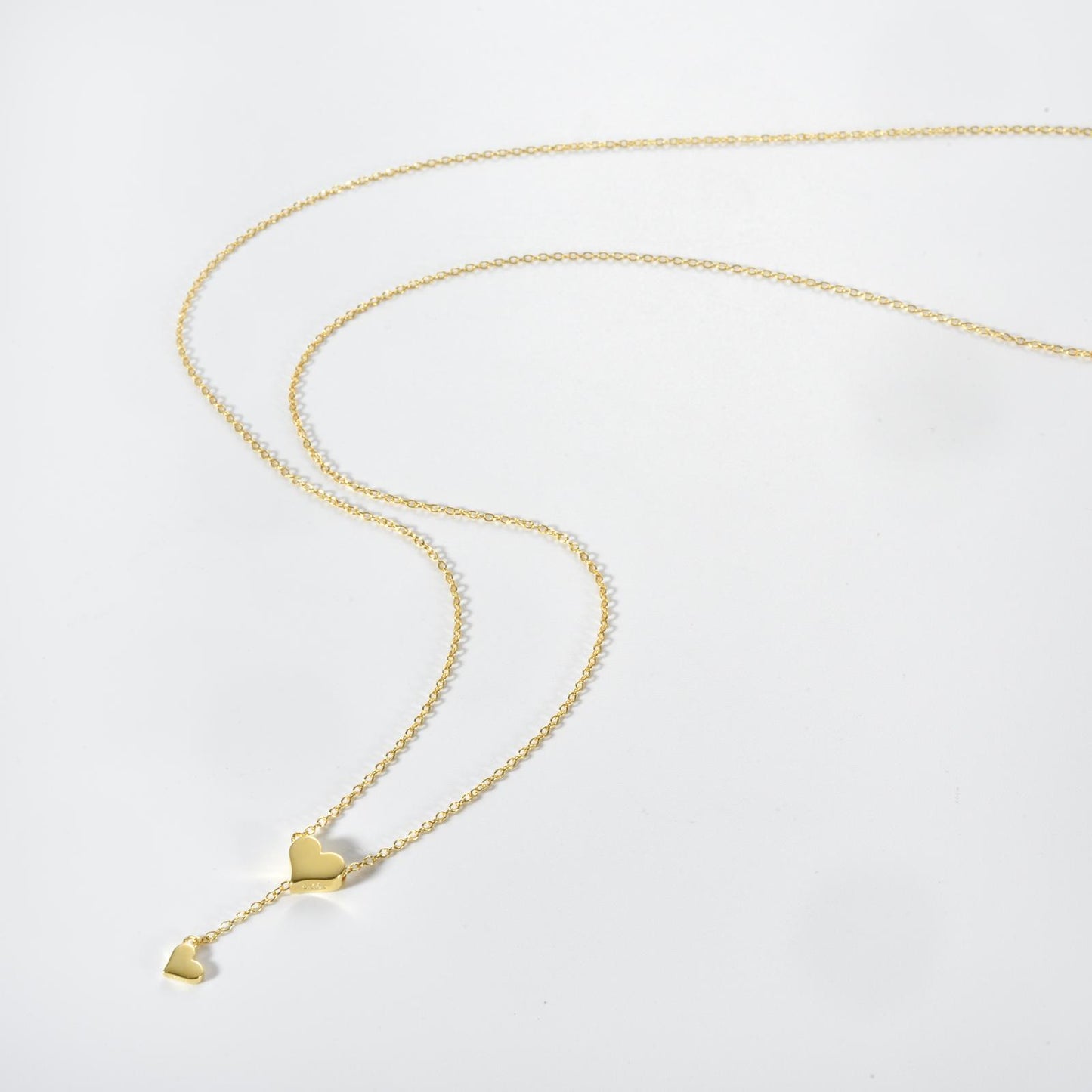 Delicate silver heart pendant necklace with a shimmering zircon center on a sleek 65cm snake chain, perfect for office elegance.