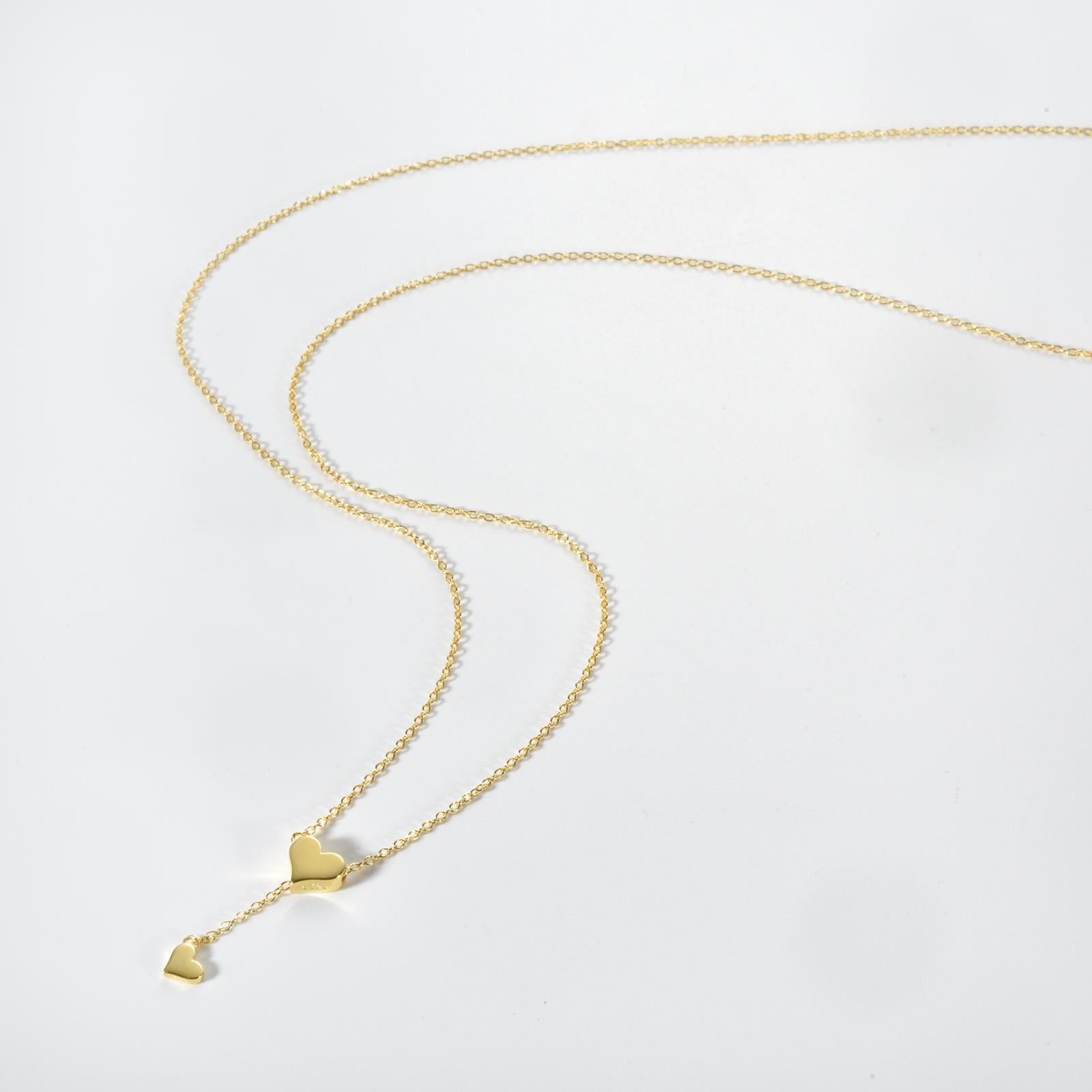 Delicate silver heart pendant necklace with a shimmering zircon center on a sleek 65cm snake chain, perfect for office elegance.