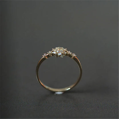 Delicate 925 sterling silver ring with 14k gold plating, featuring a romantic snowflake design and sparkling zircon center.