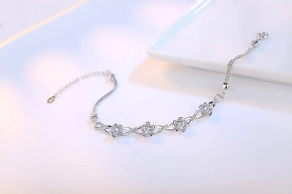 Delicate 925 sterling silver bracelet with a plant motif, sparkling cubic zirconia, and crystal accents for elegant style.