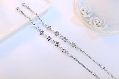 Delicate 925 sterling silver bracelet with a plant motif, sparkling cubic zirconia, and crystal accents for elegant style.