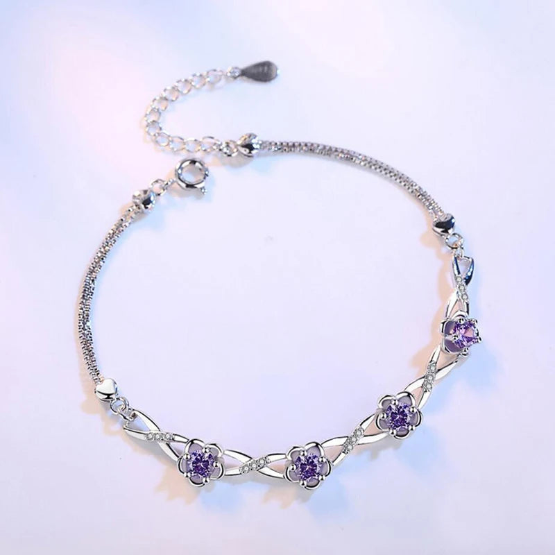 Delicate 925 sterling silver bracelet with a plant motif, sparkling cubic zirconia, and crystal accents for elegant style.