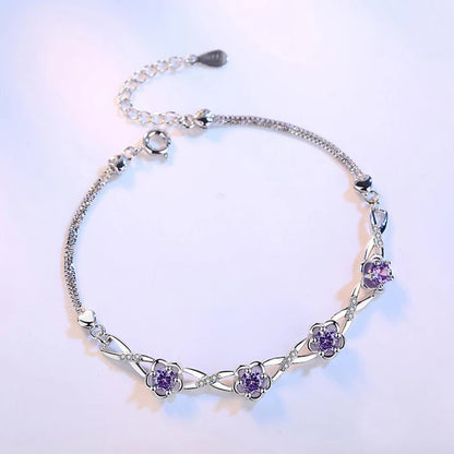 Delicate 925 sterling silver bracelet with a plant motif, sparkling cubic zirconia, and crystal accents for elegant style.