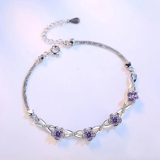 Delicate 925 sterling silver bracelet with a plant motif, sparkling cubic zirconia, and crystal accents for elegant style.