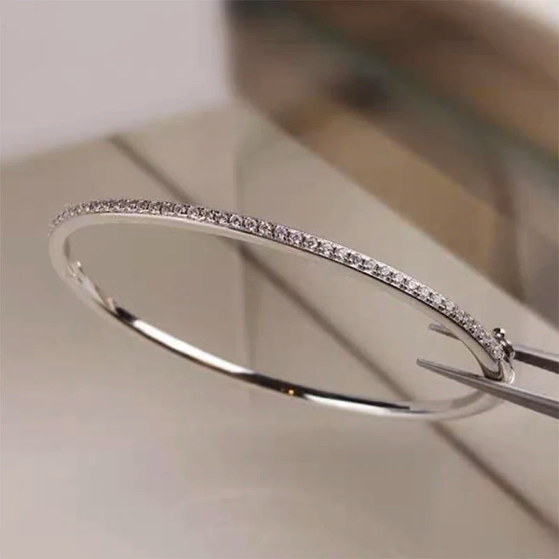 Elegant gold-filled sterling silver bangle with a sparkling zircon stone centerpiece, showcasing a minimalist 6cm round design.