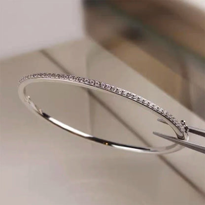 Elegant gold-filled sterling silver bangle with a sparkling zircon stone centerpiece, showcasing a minimalist 6cm round design.