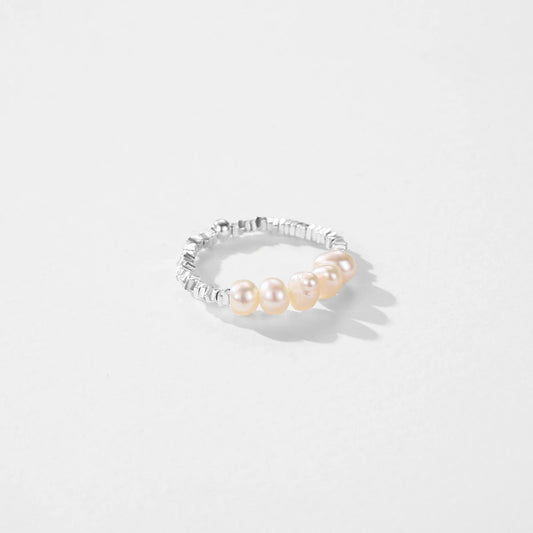 Delicate 925 sterling silver ring with a lustrous pearl centerpiece, set in a sleek geometric band for timeless elegance.