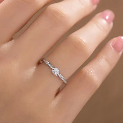 Elegant 925 sterling silver bridal ring set featuring a sparkling 5mm round brilliant moissanite in a classic 4-prong solitaire setting.