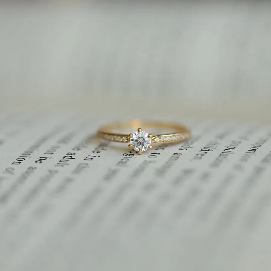 Elegant 925 sterling silver ring plated in 14K gold, featuring a sparkling 4mm zircon stone in a geometric 2mm band.