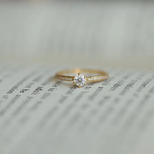 Elegant 925 sterling silver ring plated in 14K gold, featuring a sparkling 4mm zircon stone in a geometric 2mm band.