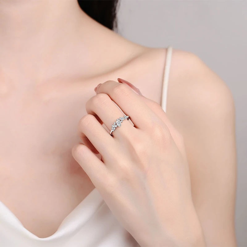 Elegant marquise-cut moissanite solitaire ring in sterling silver, showcasing a sparkling 6x3mm stone in a 4-prong setting.