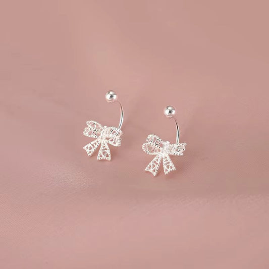 Delicate 925 sterling silver bowknot stud earrings with a charming, romantic design, perfect for any special occasion.