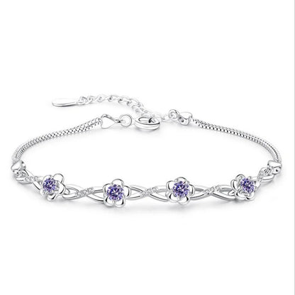 Delicate 925 sterling silver bracelet with a plant motif, sparkling cubic zirconia, and crystal accents for elegant wear.