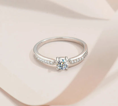 Stunning 925 Sterling Silver Bridal Ring Set featuring a sparkling 5mm round brilliant Moissanite in a classic 4-prong solitaire setting.