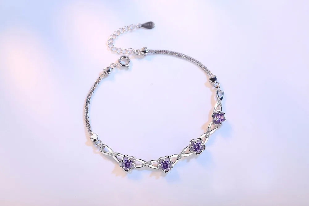 Delicate 925 sterling silver bracelet with a plant motif, sparkling cubic zirconia, and crystal accents for elegant style.