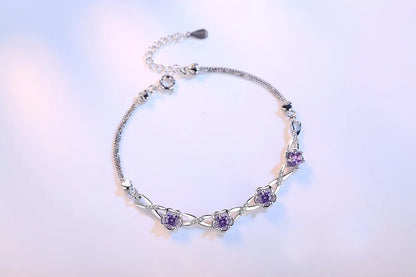 Delicate 925 sterling silver bracelet with a plant motif, sparkling cubic zirconia, and crystal accents for elegant style.