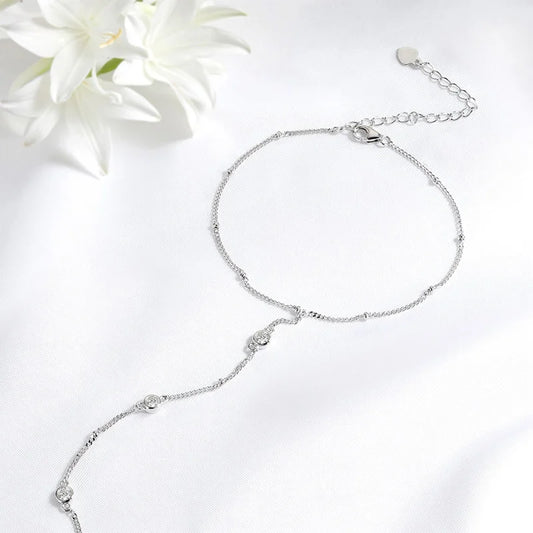 Gleaming 925 sterling silver bracelet with sparkling 18K-plated Moissanite stones in a timeless, unisex charm design.