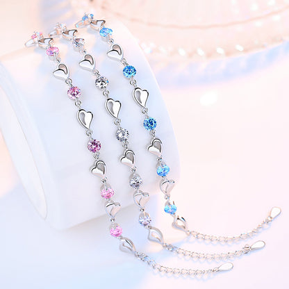 Delicate 925 sterling silver bracelet with sparkling zircon crystals forming a charming heart-shaped design.