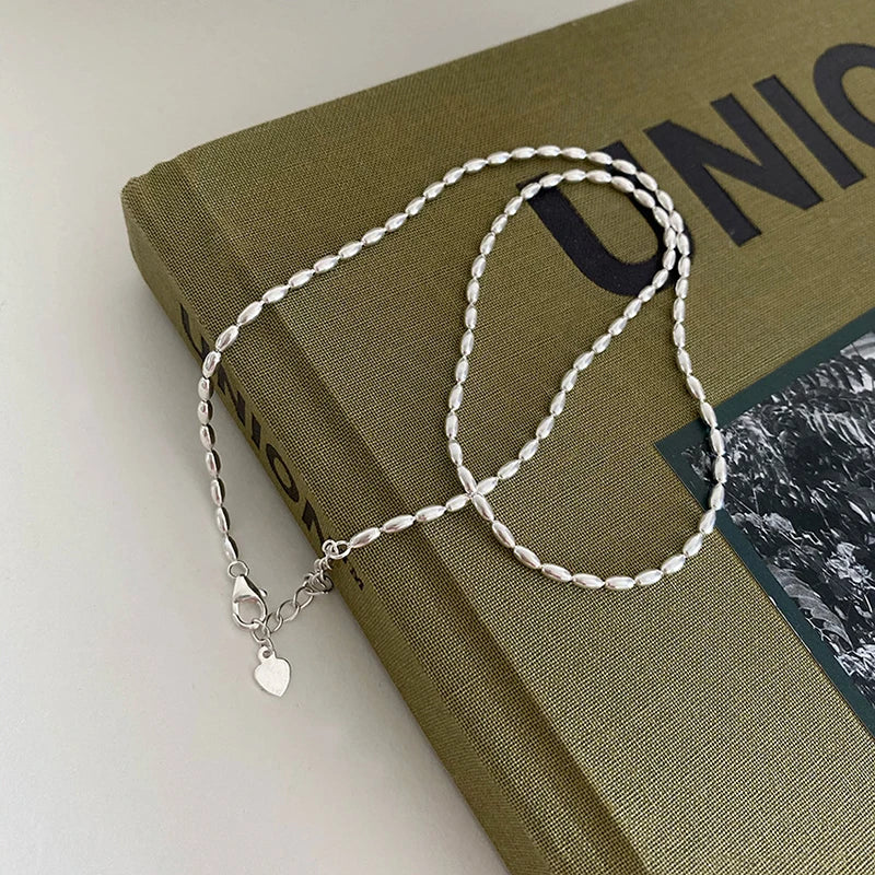 Elegant sterling silver necklace with a geometric zircon pendant sparkling on a delicate 40cm box chain.