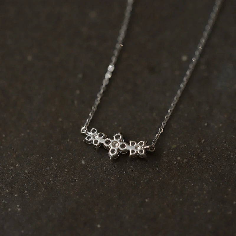 Delicate 925 sterling silver necklace with a sparkling moissanite four-leaf clover pendant, perfect for luck and love.