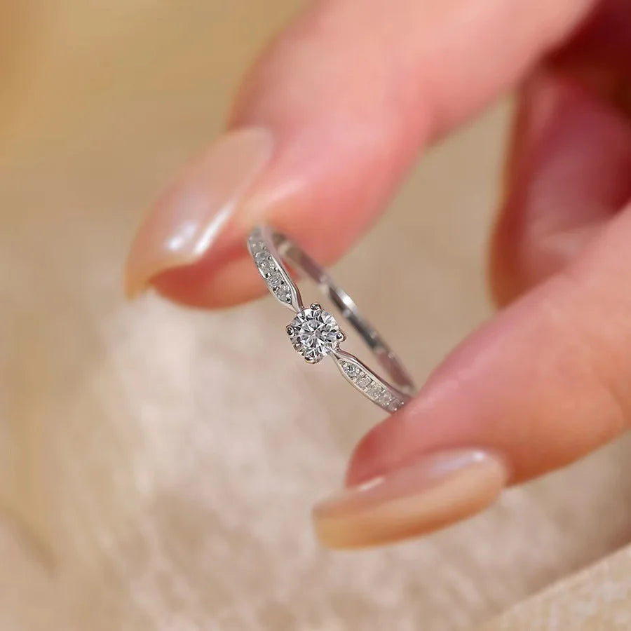 Stunning 925 sterling silver bridal ring set featuring a sparkling 5mm round brilliant moissanite in a classic 4-prong solitaire setting.