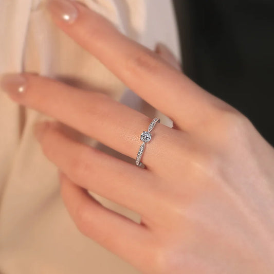 Elegant 925 sterling silver bridal ring set featuring a sparkling 5mm round brilliant moissanite in a classic 4-prong solitaire setting.