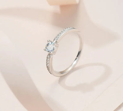 Elegant 925 sterling silver bridal ring set featuring a sparkling 5mm round brilliant moissanite in a classic 4-prong solitaire setting.