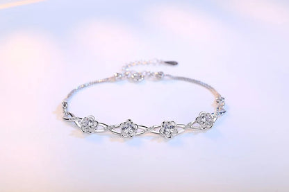 Delicate 925 sterling silver bracelet with a plant motif, sparkling cubic zirconia, and crystal accents for elegant wear.