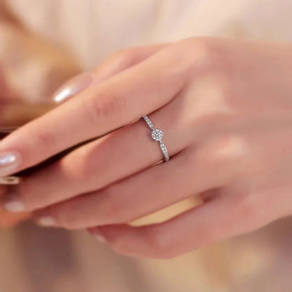 Elegant 925 sterling silver bridal ring set featuring a sparkling 5mm round brilliant moissanite in a classic 4-prong solitaire setting.